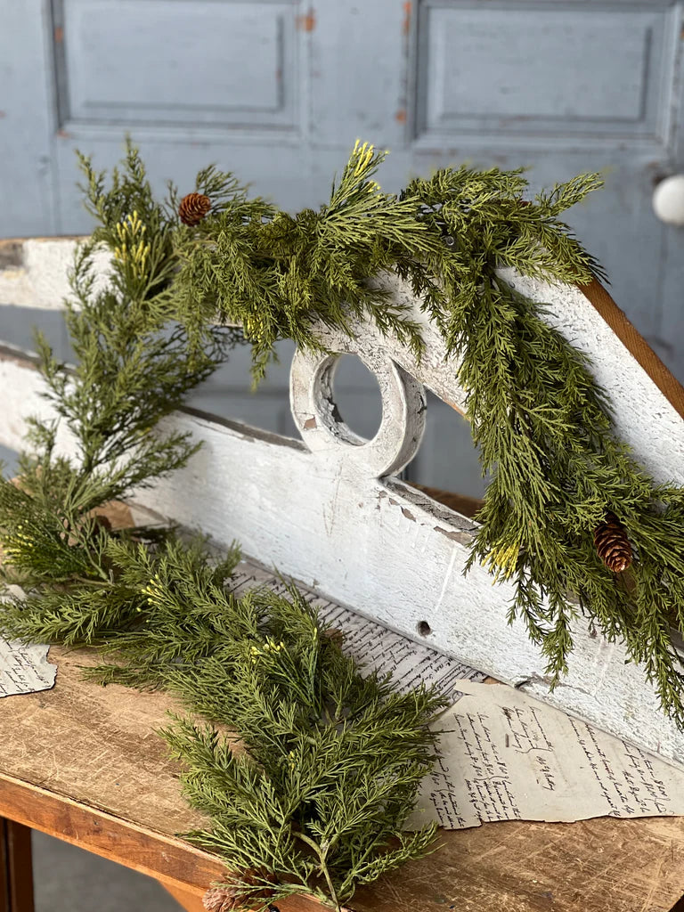 Greenery on a rustic wooden surface with a gray background