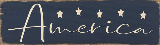 Wooden sign with 'America' and star designs on a rustic wooden surface