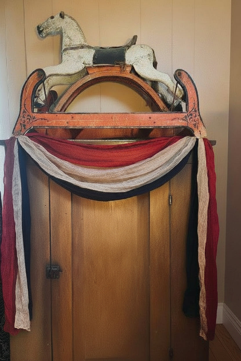 Vintage wooden rocking horse with a decorative arch against a beige wall.
