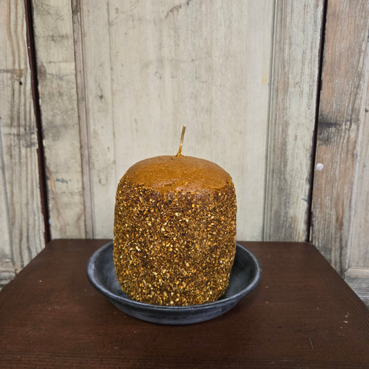 Brown textured candle on a wooden surface