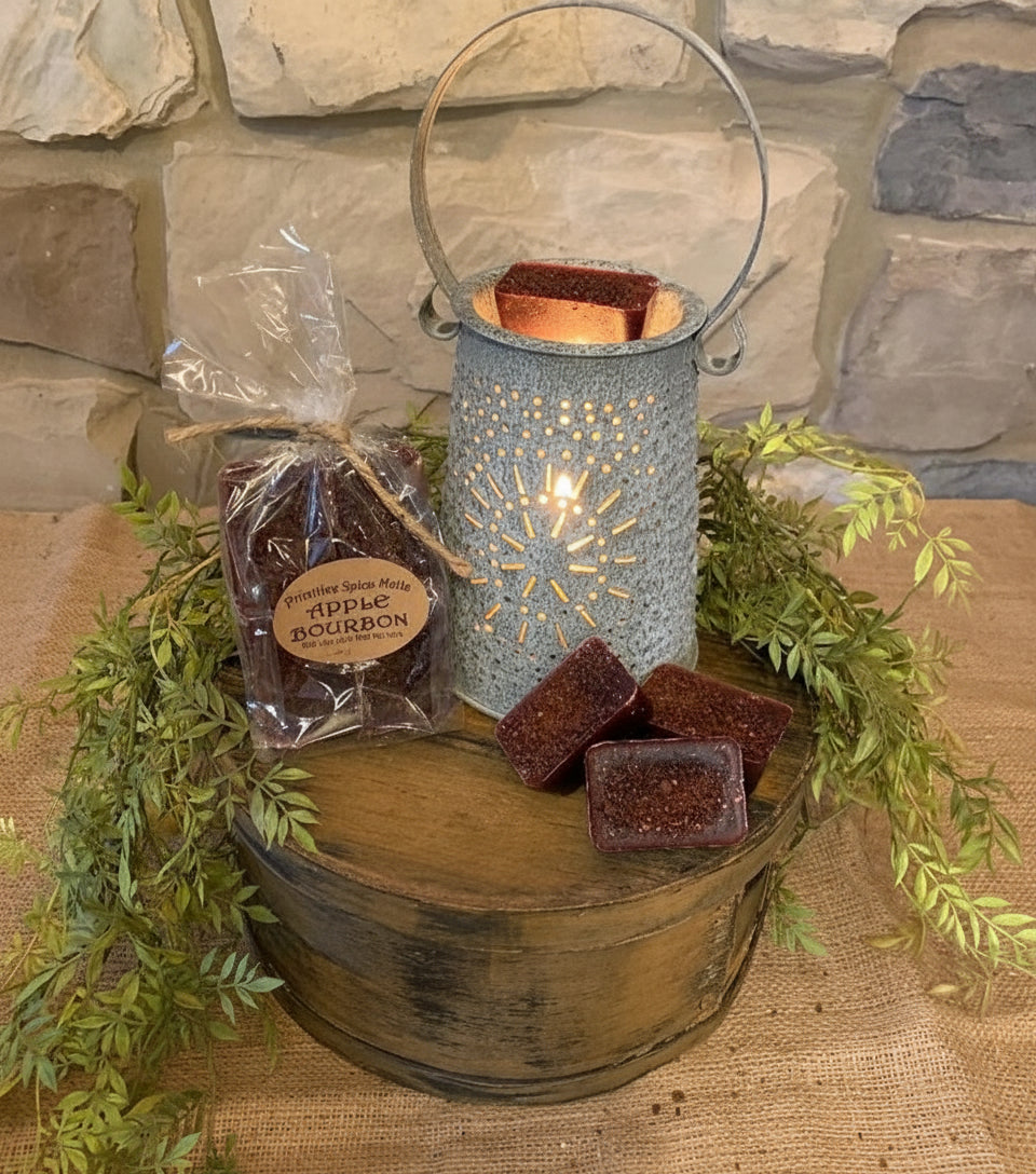 Wax pieces in a metal container and plastic bag on a stone surface with greenery.