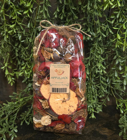 Packaged apple pie spice mix with a label on a decorative background of greenery
