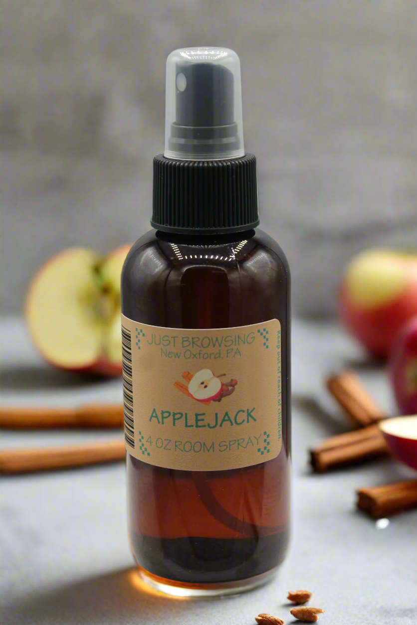 A 4oz bottle of Applejack room spray with a mist spray top. The label features the product name and a brief description.