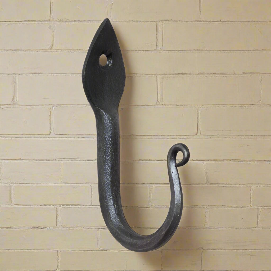 Wrought iron arrow head wall hook on white background
