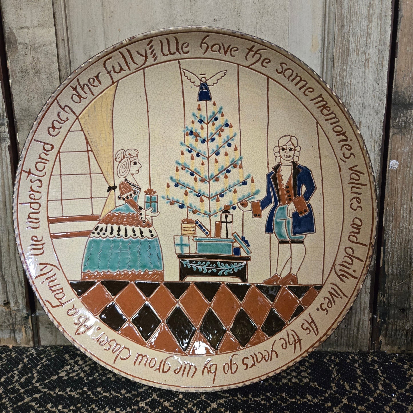 Decorative plate with a checkered pattern and artistic illustrations on a wooden surface.