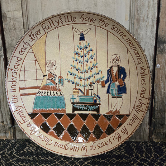 Decorative plate with a checkered pattern and artistic illustrations on a wooden surface.
