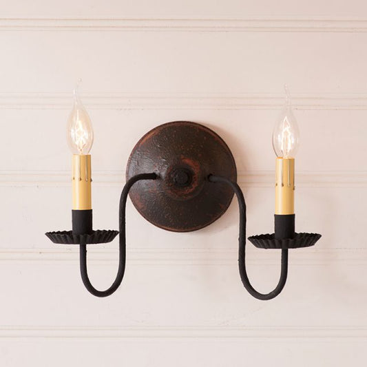 Double wall sconce with black and gold design on a light background