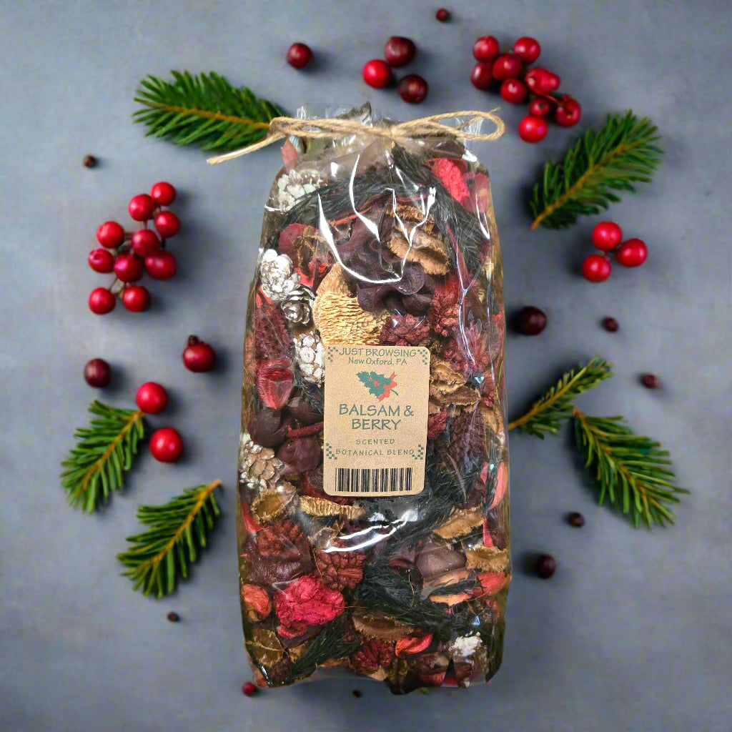 Bag of dried flowers and herbs with a label on a green leafy background