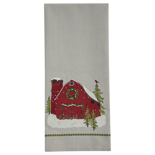 A Christmas-themed dishtowel featuring a barn design with a holiday decoration in the center, surrounded by a green border.