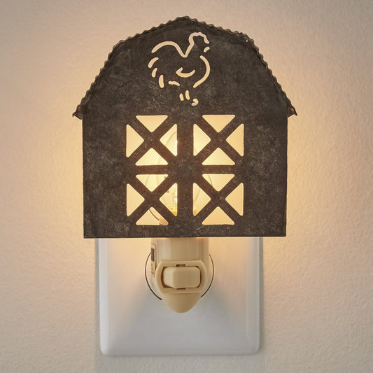 Galvanized barn night light plugged into a wall outlet