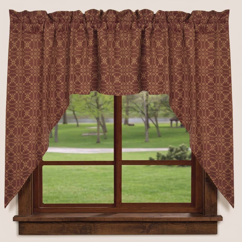 Barn red and tan Marshfield jacquard swag curtains with gathered tops and curved sides framing a wooden window overlooking a green lawn.