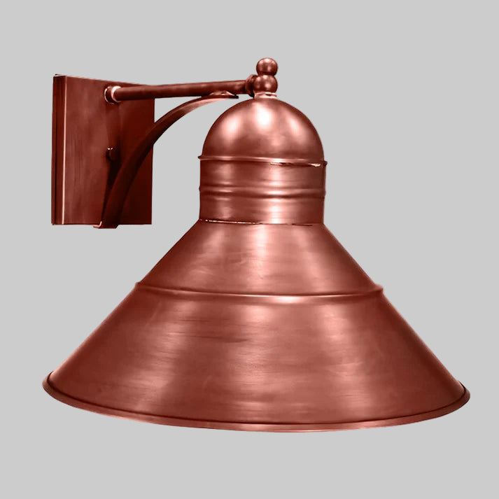Copper wall-mounted light fixture on a gray background