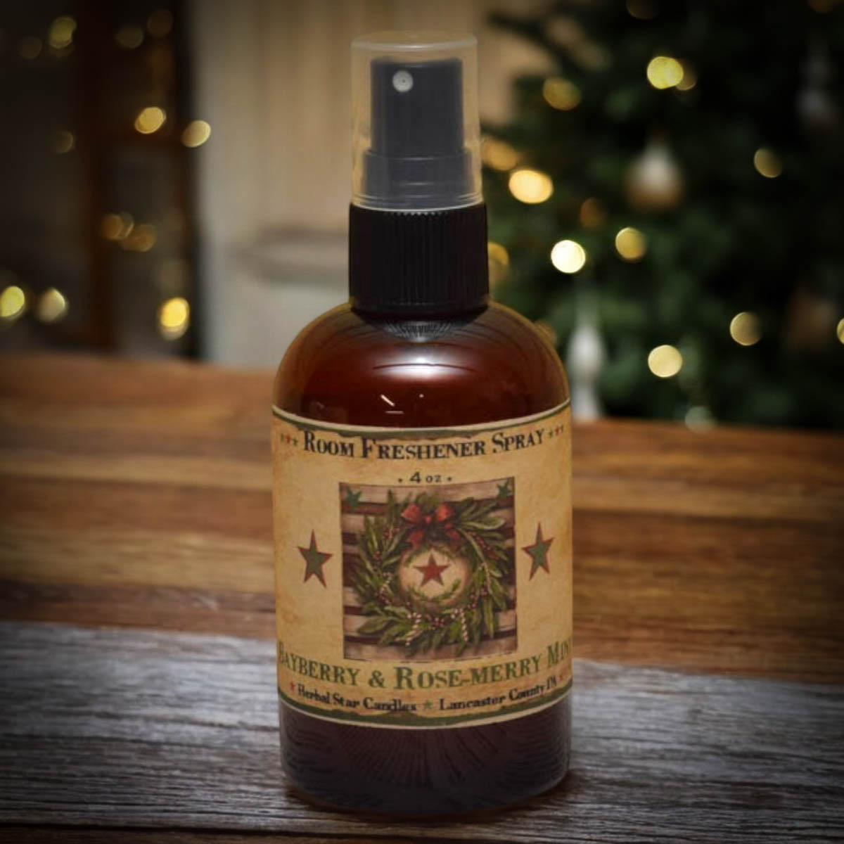 Room freshener spray bottle with a festive label on a wooden surface with blurred lights in the background