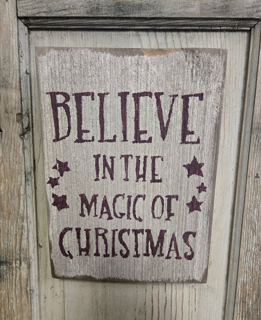 Weathered sign about Christmas on a wood door
