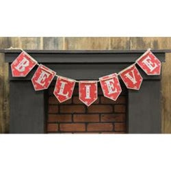 A metal garland with pennants spelling out the word 'BELIEVE' on a red background with white snowflakes, hanging over a fireplace.