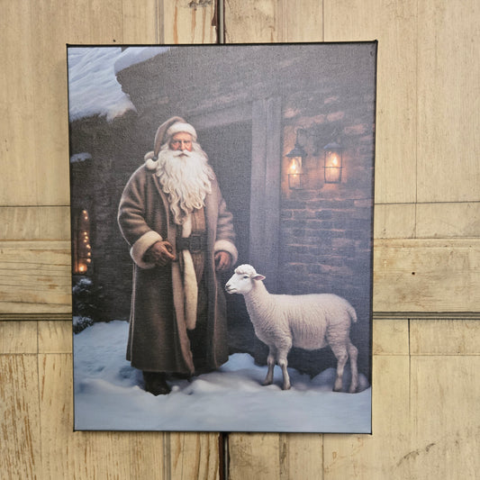 Framed artwork of a man with a long beard interacting with two sheep on a wooden floor.