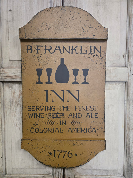 Decorative sign for B. Franklin Inn with vintage design on a wooden background