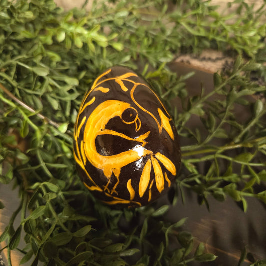 Brown redware egg with yellow glazed bird on a flower stem
