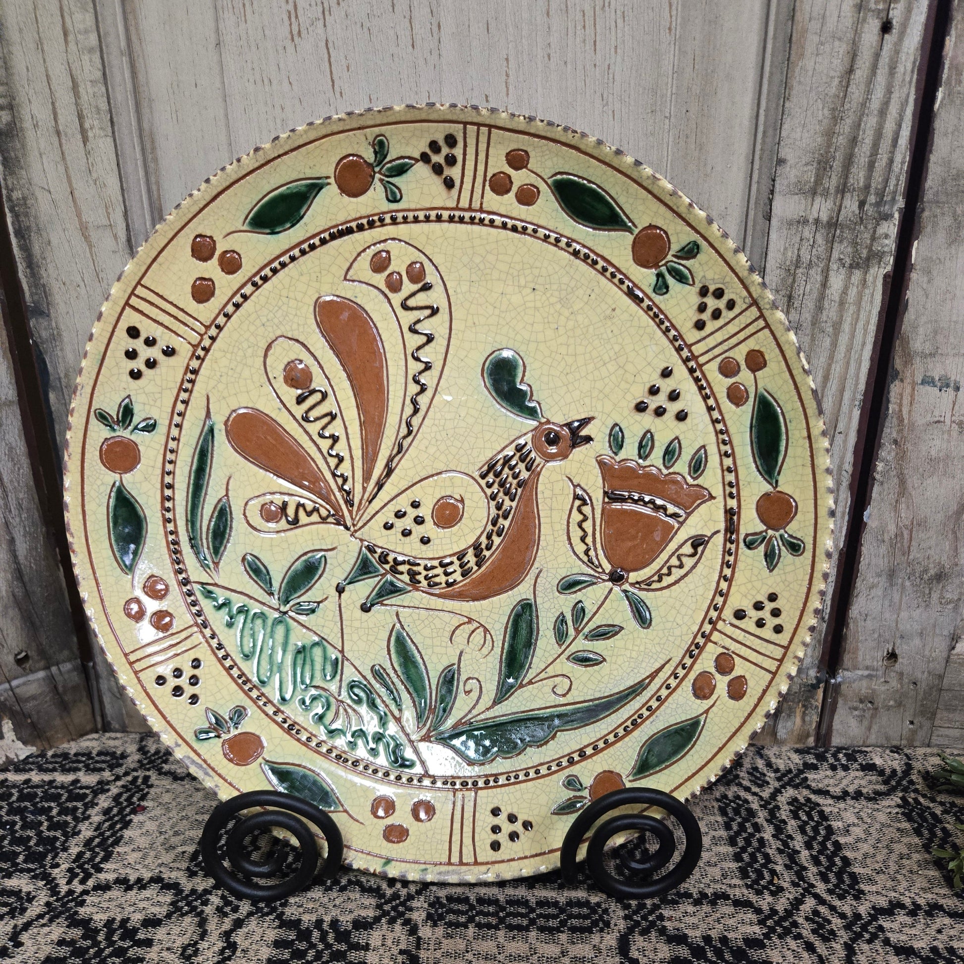 Decorative plate with a bird design on a wooden surface