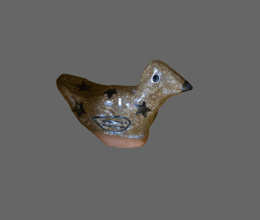 A miniature stoneware sculpture of a bird with a glazed finish in various colors.