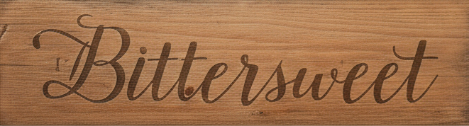Wooden sign with 'Bittersweet' engraved in cursive on a wooden background