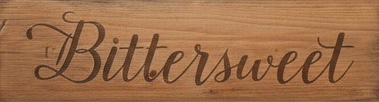Wooden sign with 'Bittersweet' engraved in cursive on a wooden background