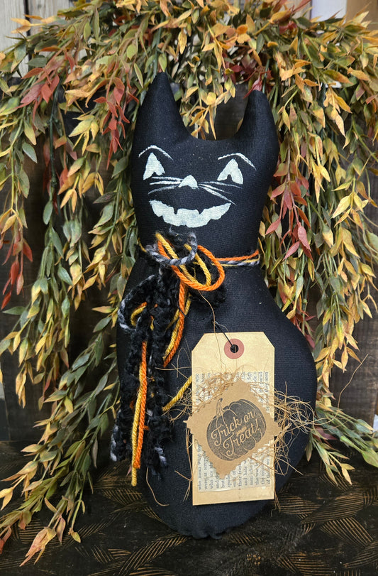 Black cat decoration with a tag on a wreath