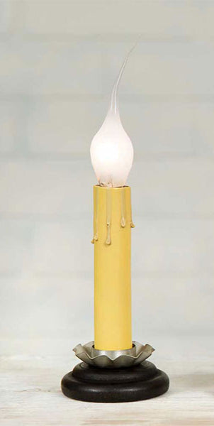 A black candle holder with a lit candle, the holder appears to be made of metal with a matte finish.
