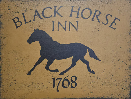 Decorative sign for Black Horse Inn with a horse silhouette on a wooden background