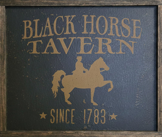 Sign in wood frame with a horse rider silhouette.