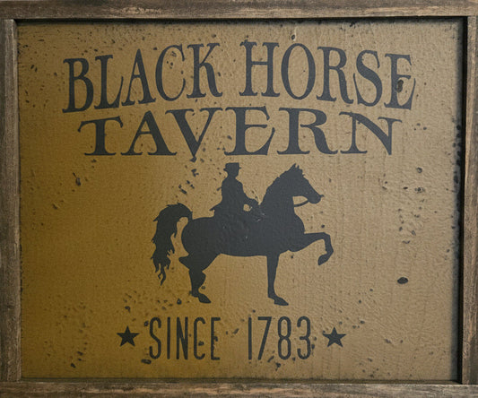 Framed wood sign with horse back rider silhouette.