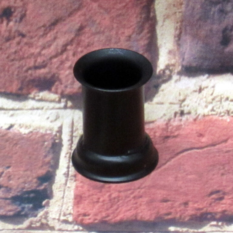 Candle cup sitting on a brick surface