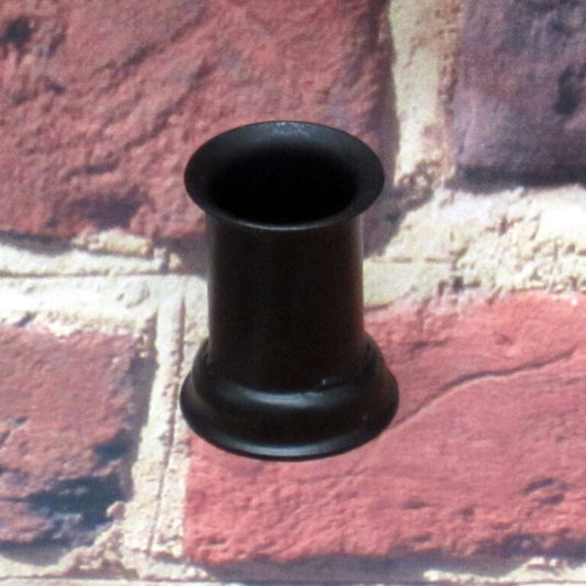 Candle cup sitting on a brick surface