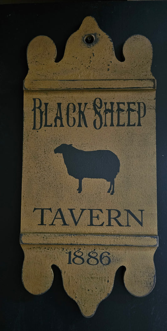 A rustic wooden hanging sign for 'Black Sheep Tavern' with a distressed tan finish and dark lettering, featuring a sheep silhouette and the year '1886' on a dark background.
