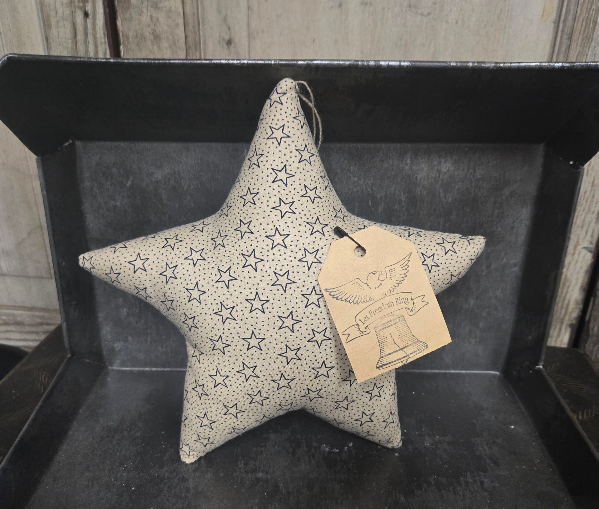 Star-shaped decorative item with a tag on a dark surface