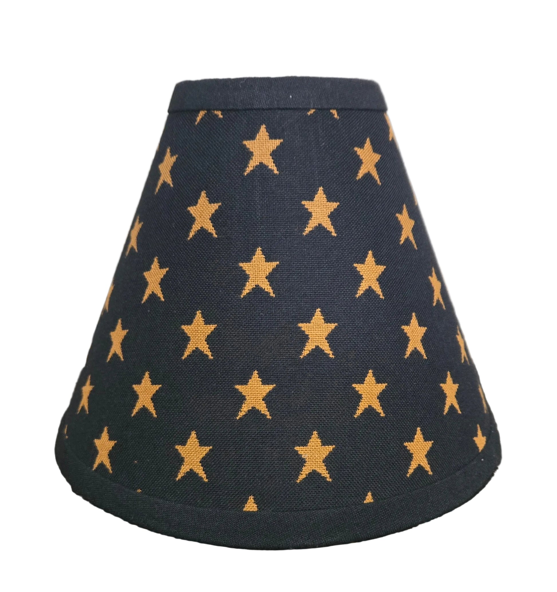 Black lampshade with gold star pattern on a wooden surface
