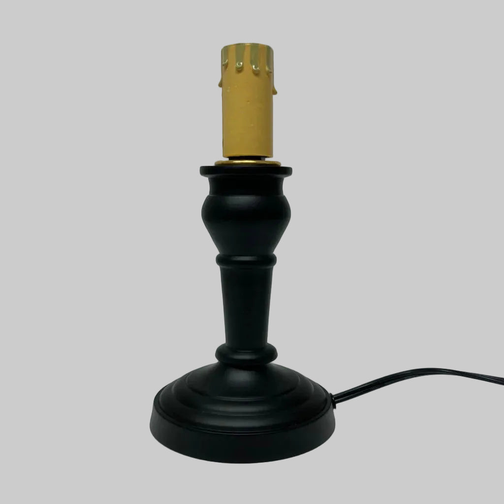Black lamp base with gold socket on a white background