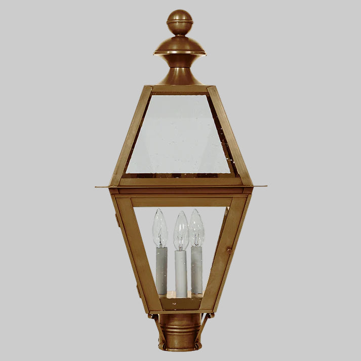 Bronze outdoor lamp with clear glass panels on a gray background