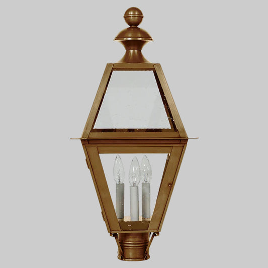 Bronze outdoor lamp with clear glass panels on a gray background