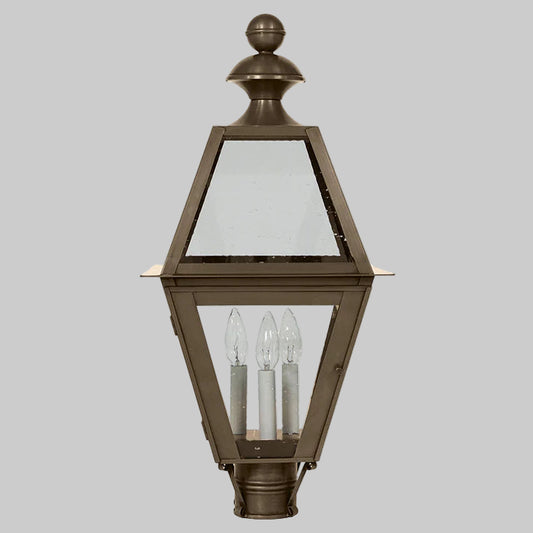 Bronze outdoor lantern with clear glass on a gray background