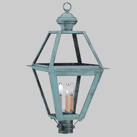 Vintage-style outdoor lamp with a metallic finish on a gray background