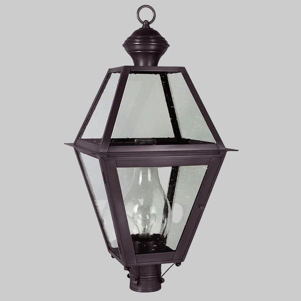 Decorative outdoor lamp with clear glass panels on a gray background
