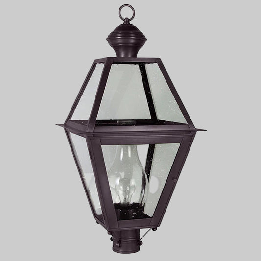Decorative outdoor lamp with clear glass panels on a gray background