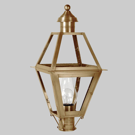 Decorative outdoor lamp with brass finish and clear glass on a white background