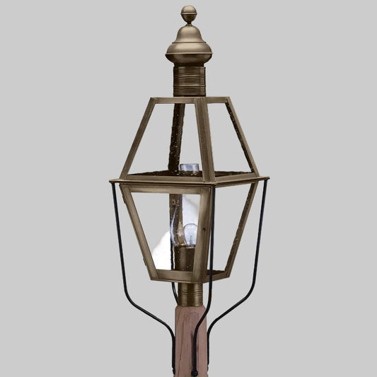 Bronze outdoor lamp post with clear glass shade on a gray background