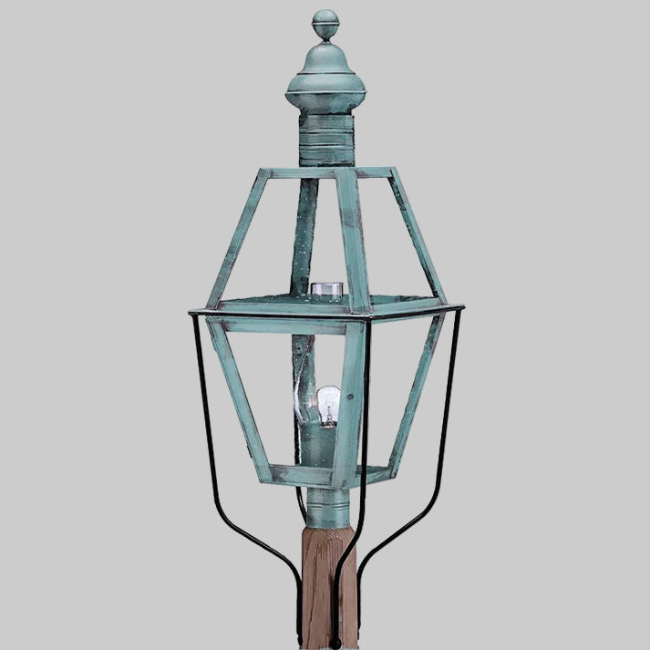 Vintage-style outdoor lamp with a metallic finish on a gray background