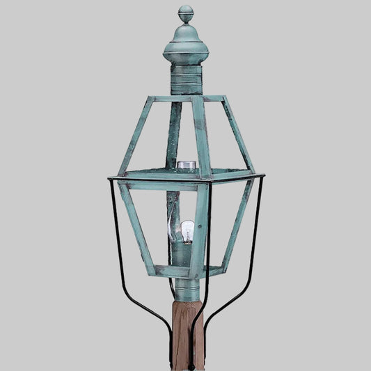 Vintage-style outdoor lamp with a metallic finish on a gray background
