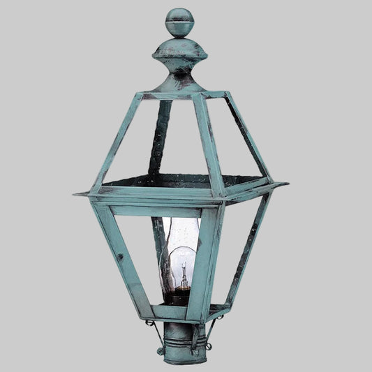 Vintage-style outdoor lamp with a metallic finish on a gray background