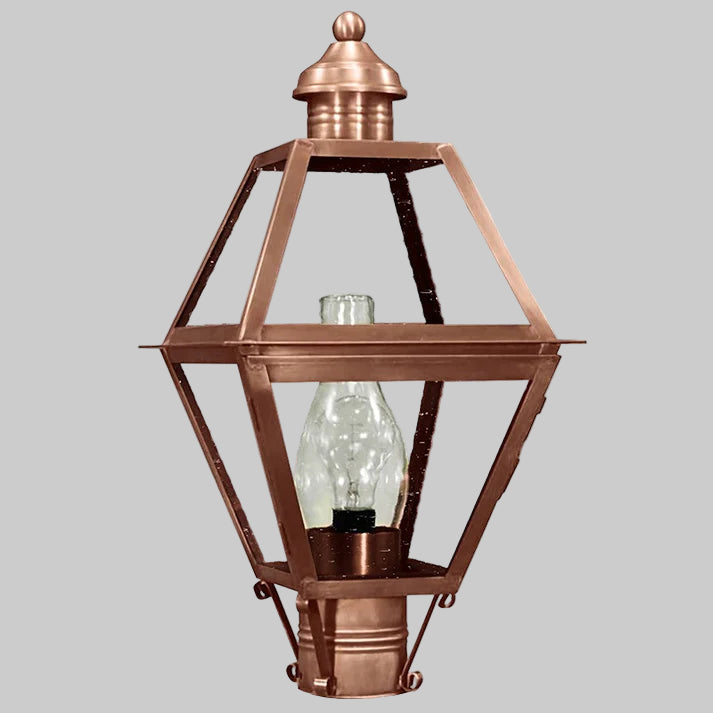 Copper outdoor lamp with clear glass shade on a gray background