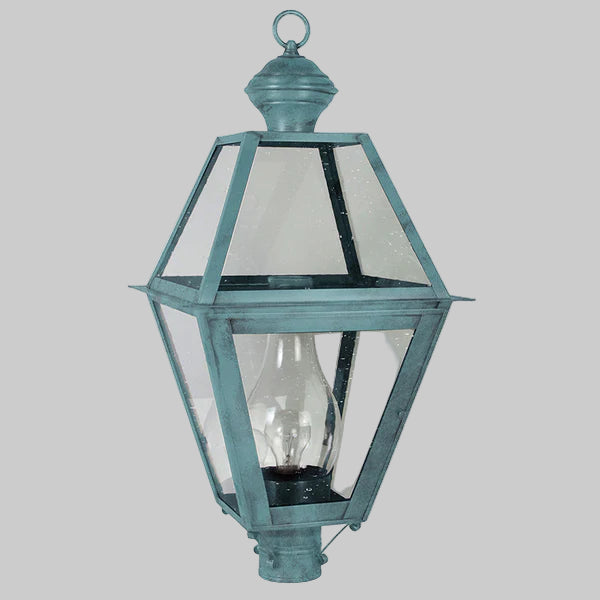 Vintage-style outdoor lamp with clear glass shade on a gray background